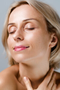 Woman with clear, healthy skin on a grey background, Park Square Clinic Leeds