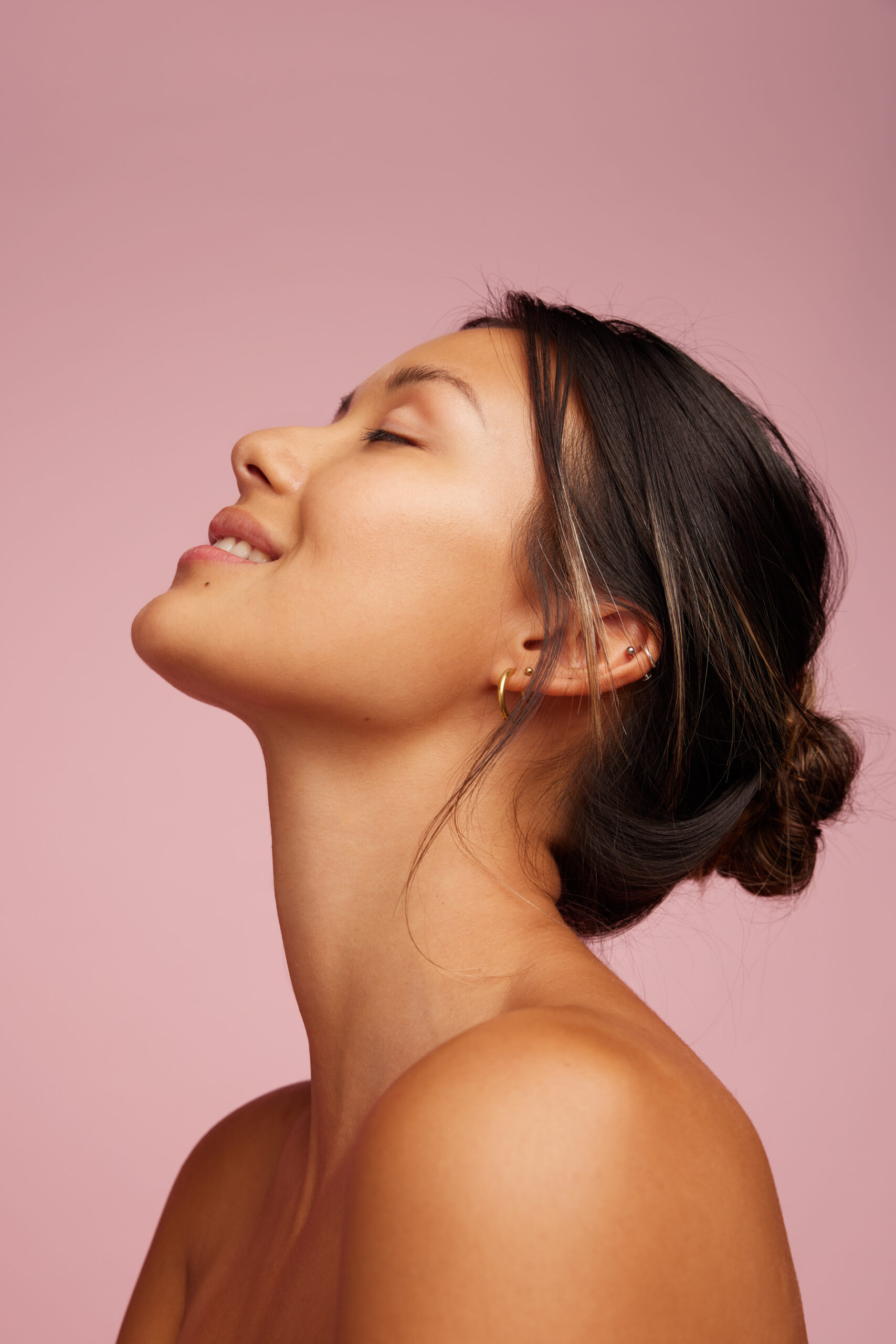 Happy young woman with healthy, glowing skin free from acne and blemishes