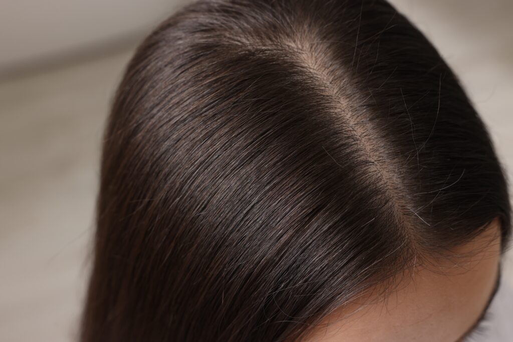 Close-up of a woman with strong, healthy hair after thinning hair treatment