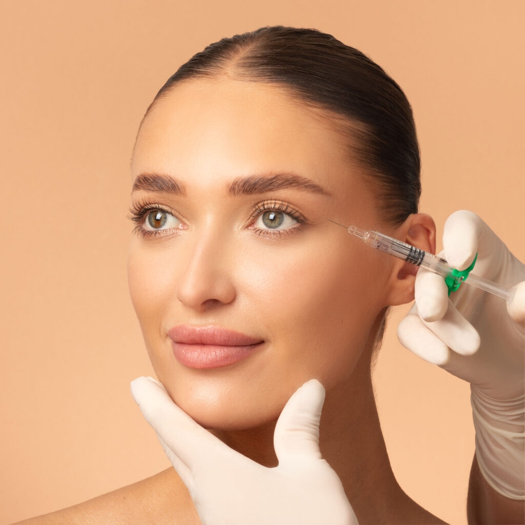 Aesthetic practitioner performing dermal filler injection around the eyes